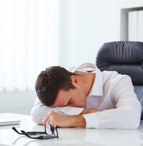 person sleeping at a desk